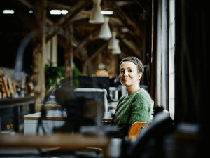 smiling-businesswoman-sitting-at-workstation.jpg